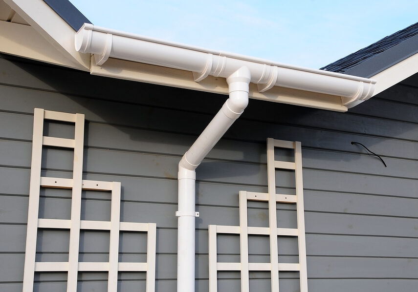 new rain gutter on a home against blue sky.